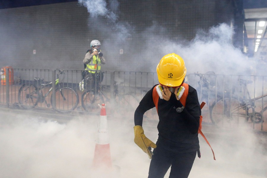 HK police fire tear gas at protesters as confrontation looms