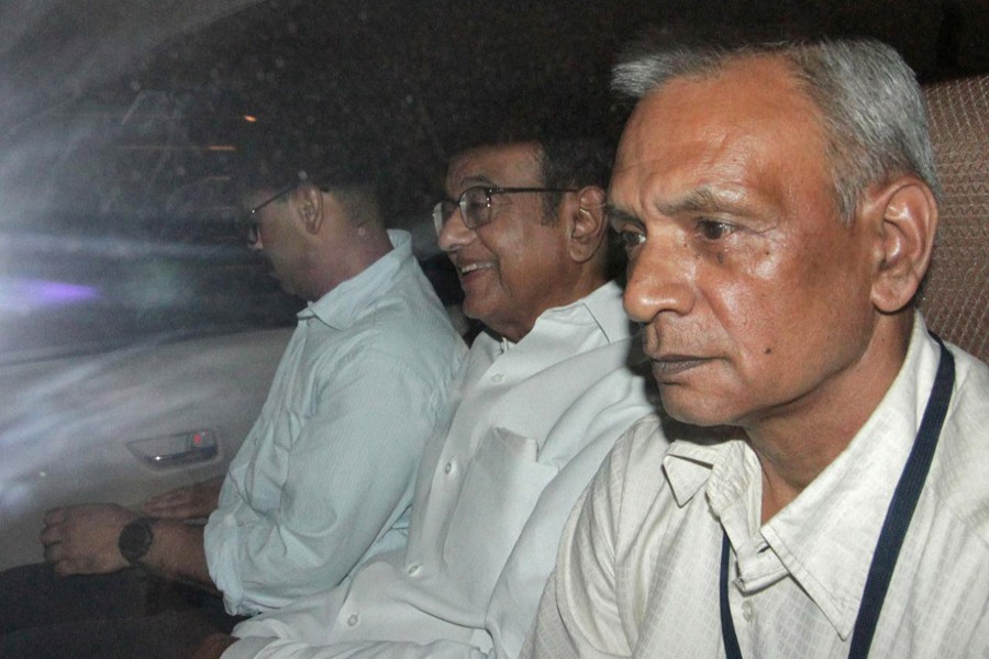 India's former Finance Minister Palaniappan Chidambaram (C) sits in a vehicle after he was arrested by the Central Bureau of Investigation (CBI) officials in his residence in New Delhi, India, August 21, 2019. Reuters/Stringer