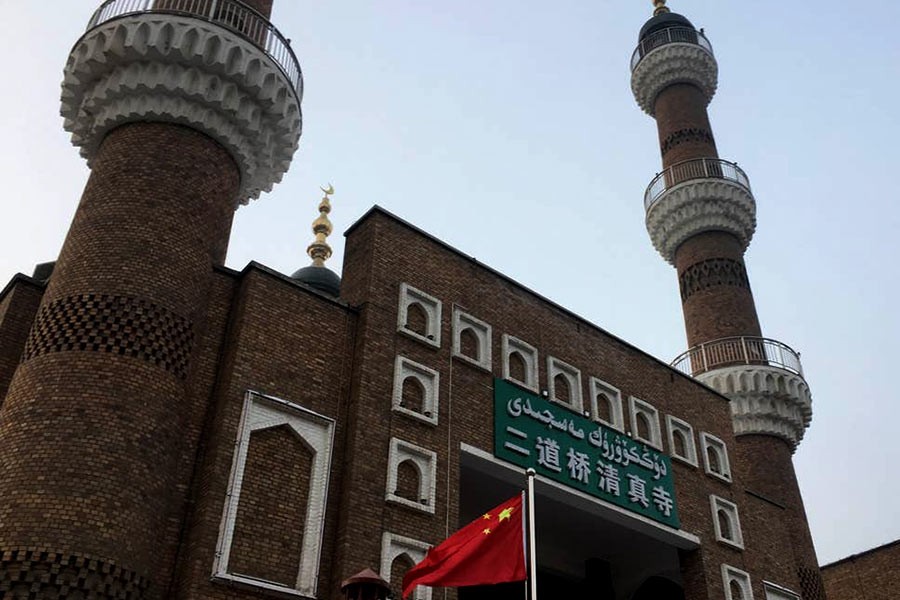 The Chinese national flag flies outside a mosque in Urumqi, Xinjiang. -Reuters file photo