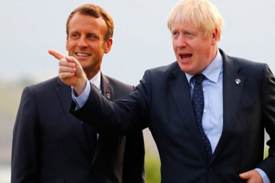 French President Emmanuel Macron, left, welcomes Britain's Prime Minister Boris Johnson at the Biarritz lighthouse, southwestern France, ahead of a working dinner Saturday, August 24, 2019. AP
