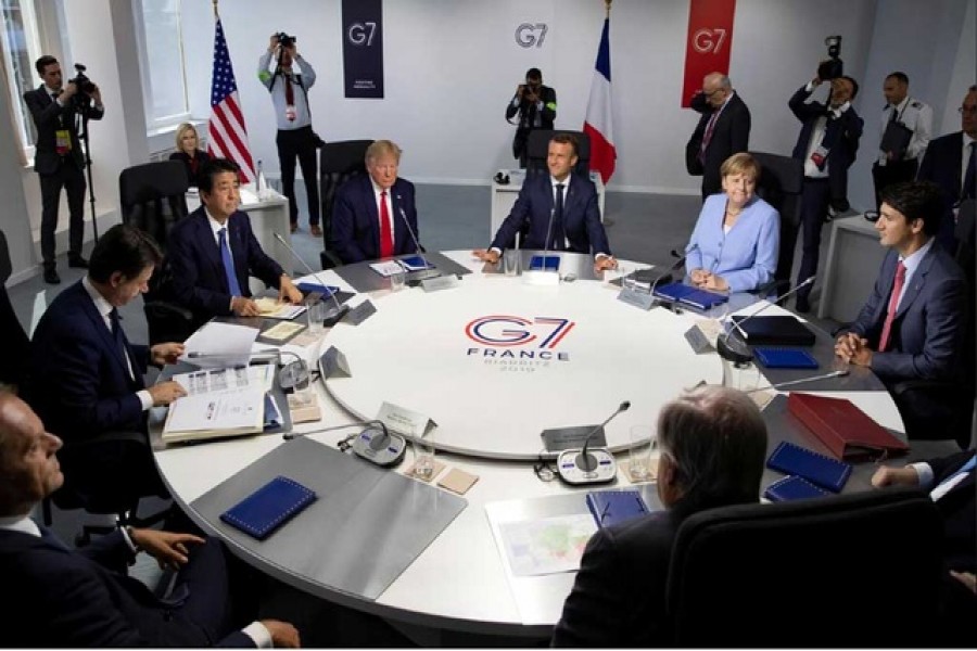 G7 summit: (L-R) EU Council President Donald Tusk, Italian Prime Minister Giuseppe Conte, Japanese Prime Minister Shinzo Abe, US President Donald Trump, French President Emmanuel Macron, German Chancellor Angela Merkel, Canadian Prime Minister Justin Trudeau attend a work session during the G7 summit in Biarritz, France, August 26, 2019. Ian Langsdon/Pool via Reuters