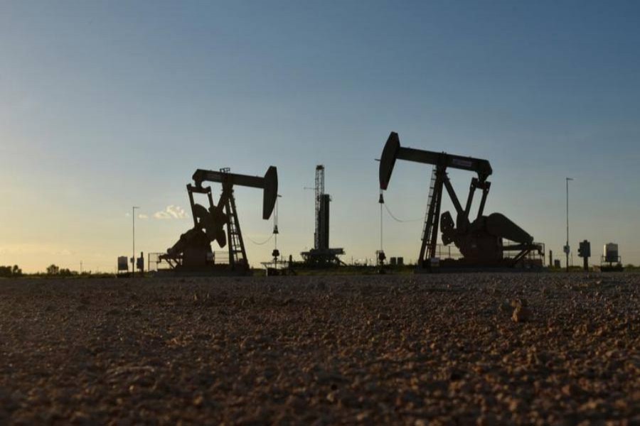 Pump jacks operating in front of a drilling rig in an oil field in Midland, Texas US 	— Reuters