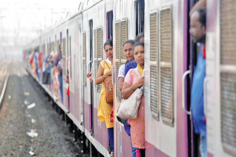 Women commuters travel by a suburban train as they head toward their destination in Mumbai, July 5, 2019. Reuters/Files