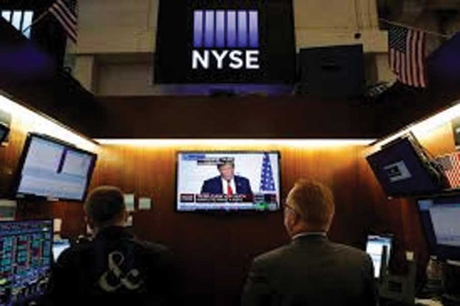 Traders watch monitors displaying a media conference with US President Donald Trump live at the G7 summit on the trading floor at the New York Stock Exchange (NYSE) in New York City, US on August 26, 2019. 	—Photo: Reuters