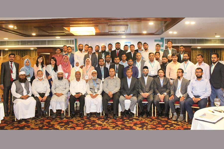 Participants posing at the concluding ceremony of the two-day international workshop on 'Islamic Capital Market and Sukuk' at a city hotel on Sunday — Collected