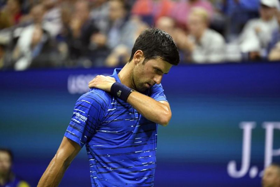 Novak Djokovic of Serbia rubs his shoulder during a match against Stan Wawrinka of Switzerland in the fourth round on day seven of the 2019 US Open tennis tournament at USTA Billie Jean King National Tennis Center — Danielle Parhizkaran-USA TODAY Sports via REUTERS