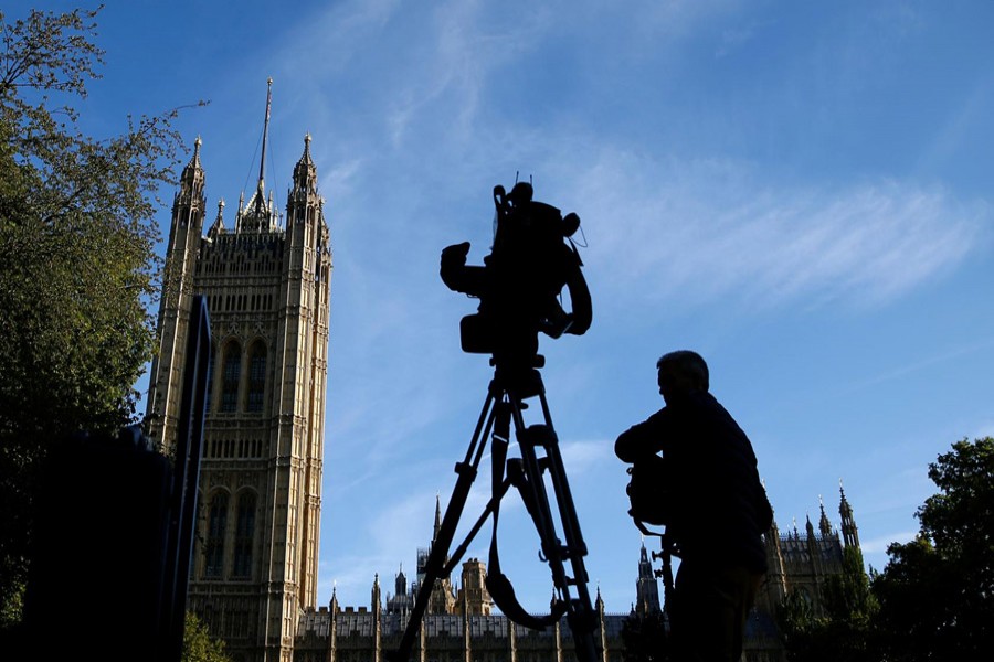 A member of the media sets up a TV camera in front of the Houses of the Parliament in London, Britain, September 2, 2019. Reuters