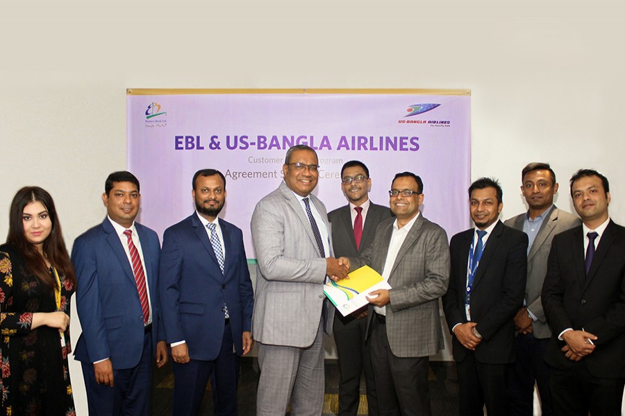 M Khorshed Anowar, Head of Retail & SME Banking of EBL and Md Shafiqul Islam, Head of Marketing & Sales of US-Bangla Airlines exchanging documents after signing an agreement in Dhaka recently