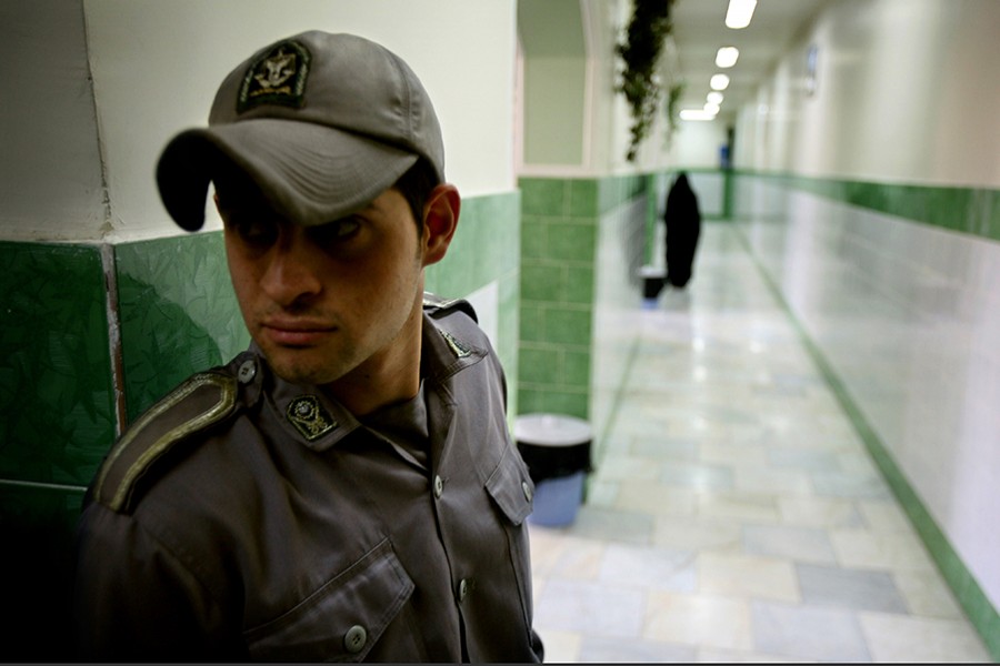 A prison guard stands along a corridor in Tehran's Evin prison — Reuters/Files