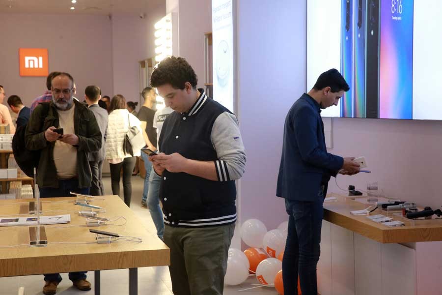 People try smartphones during the opening ceremony for the first official Xiaomi store at a shopping center in Bucharest, capital of Romania, April 20, 2019. (Xinhua/Gabriel Petrescu)