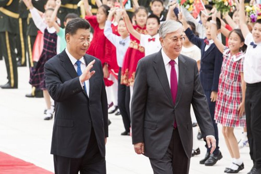 Chinese President Xi Jinping (left) and Kazakh President Kassym-Jomart Tokayev walk together at the square of the Great Hall of the People in Beijing on Wednesday. Photo: Xinhua