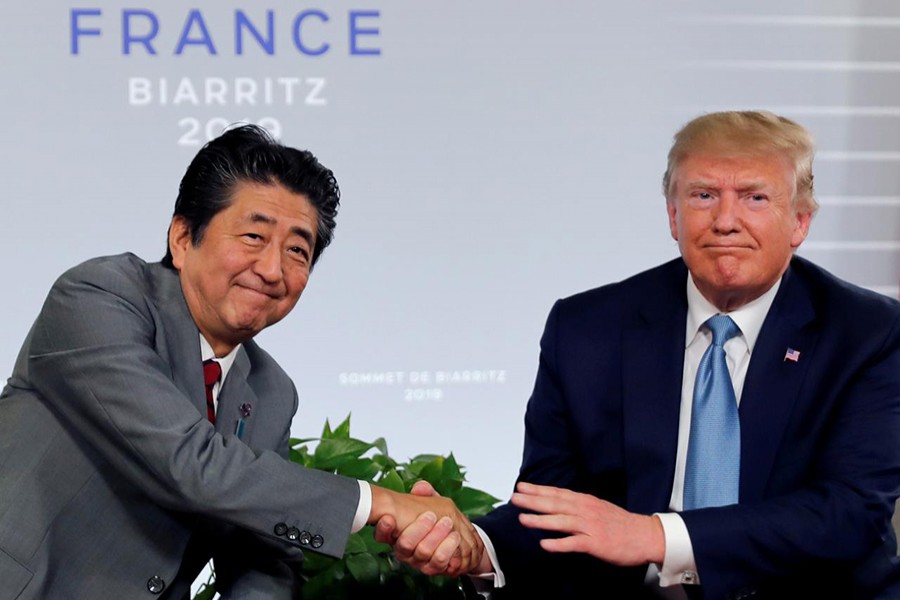 US President Donald Trump and Japan's Prime Minister Shinzo Abe shake hands at a bilateral meeting during the G7 summit in Biarritz, France on August 25, 2019 — Reuters/Files