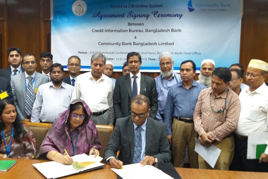 Ms Mansura Parvin, general manager of CIB, Bangladesh Bank (left) and Mr Masihul Huq Chowdhury, managing director & CEO of Community Bank seen signing the agreement on behalf of their respective sides