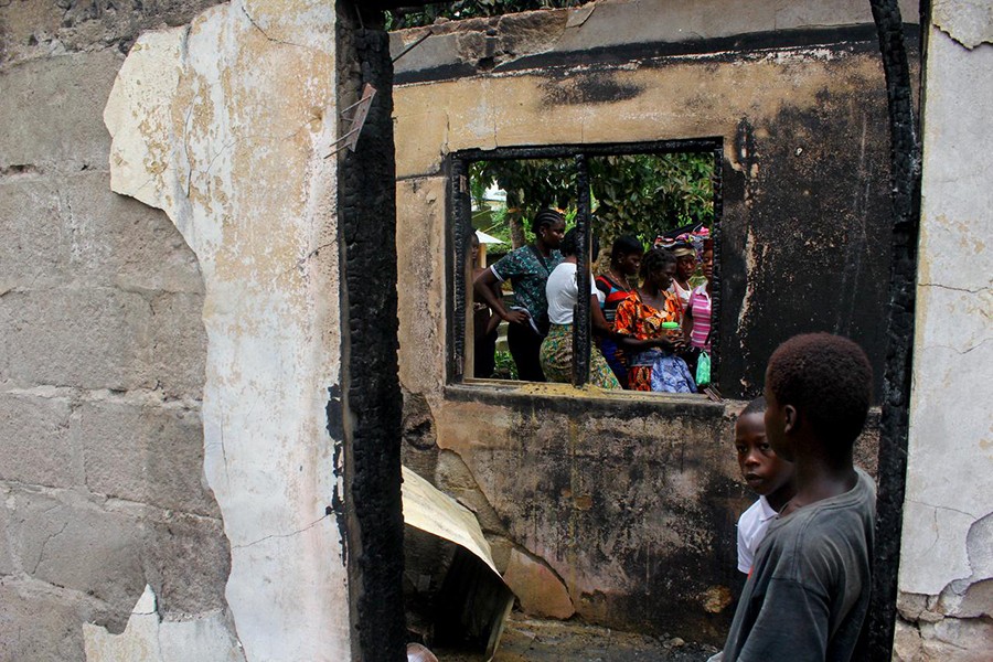 People walk through a burned building after a fire swept through a school killing children in Monrovia, Liberia on September 18, 2019 — Reuters photo
