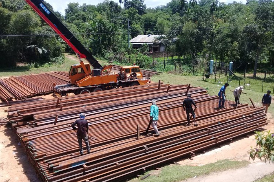 Rail tracks are stockpiled for the reconstruction of the Kulaura-Shahbajpur section of Bangladesh Railway under Indian credit programme 	— FE Photo