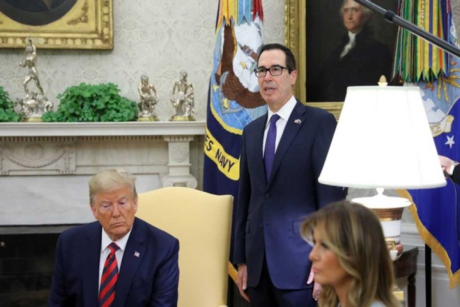 US Treasury Secretary Steven Mnuchin announces sanctions on the Central Bank of Iran as he stands behind US President Donald Trump and first lady Melania Trump in the Oval Office during a meeting with Australia's Prime Minister Scott Morrison at the White House in Washington, US, September 20, 2019. Reuters