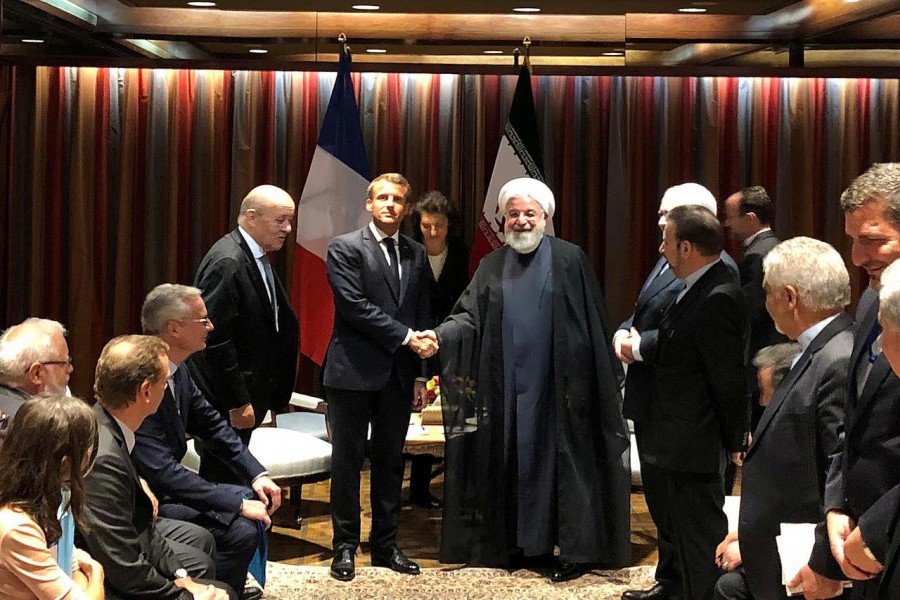 FILE PHOTO: French President Emmanuel Macron shakes hands with Iranian President Hassan Rouhani during their meeting on the sidelines of the United Nations General Assembly in New York, U.S., September 23, 2019. REUTERS/John Irish/File Photo