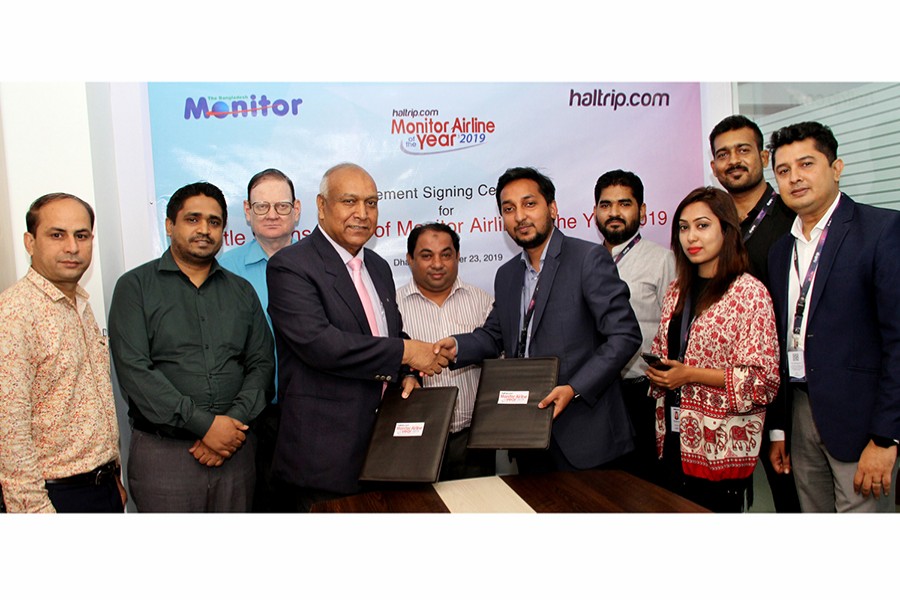 Kazi Wahidul Alam, editor, The Bangladesh Monitor (left) and Tajbir Hasan, managing director, Haltrip seen exchanging documents after signing a sponsorship deal in the capital recently