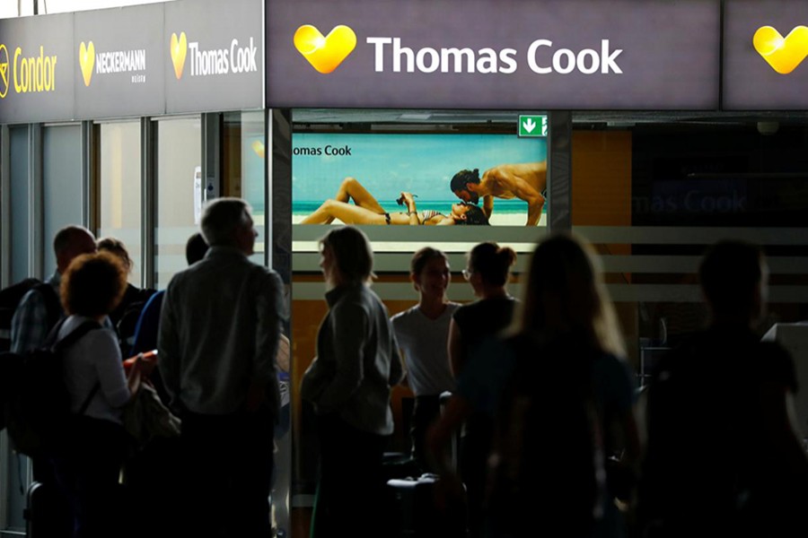 Passengers are silhouetted in front of a closed service counter of travel agent Thomas Cook and airline Condor at the airport in Frankfurt, Germany on September 24, 2019 — Reuters photo