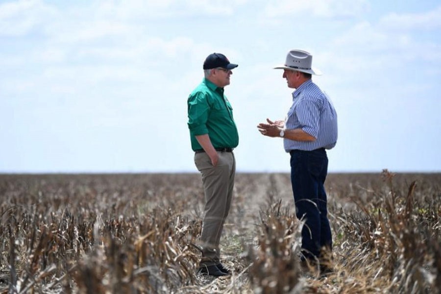 Australian Prime Minister Scott Morrison chats with farmer David Gooding on his drought-affected property near Dalby, Queensland, Australia, September 27, 2019. (Photo- AAP)