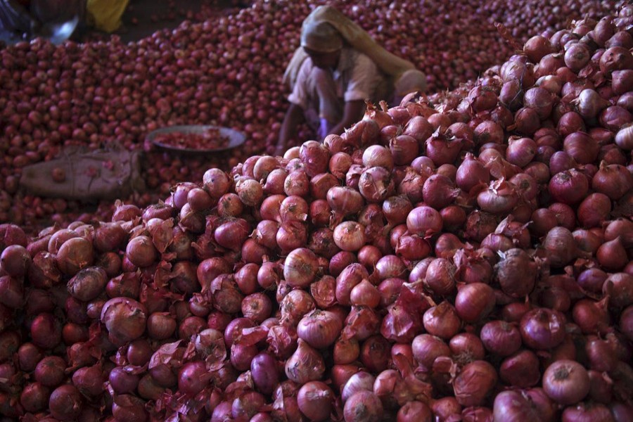 A worker sorts onions at a wholesale vegetable market in Chandigarh, India, July 24, 2015. Reuters/Files