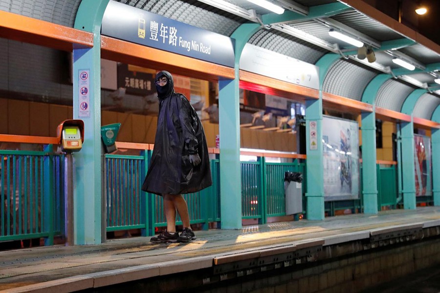 An anti-government protester wears a raining coat with half his face covered during a demonstration after a government’s ban on face masks under emergency law, at Yuen Long, in Hong Kong, China on October 5, 2019 — Reuters photo