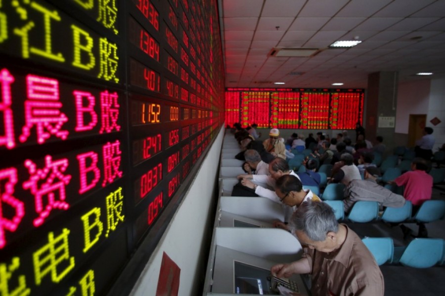 Investors tracking stock information at a brokerage house in Shanghai. Photo: Reuters