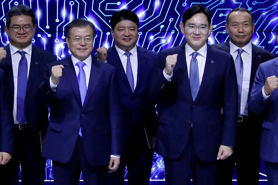 South Korean President Moon Jae-in and Samsung Electronics Vice Chairman, Jay Y Lee pose for a group photo after a signing ceremony at Samsung Display's factory in Asan, South Korea on October 10, 2019 — Yonhap via REUTERS