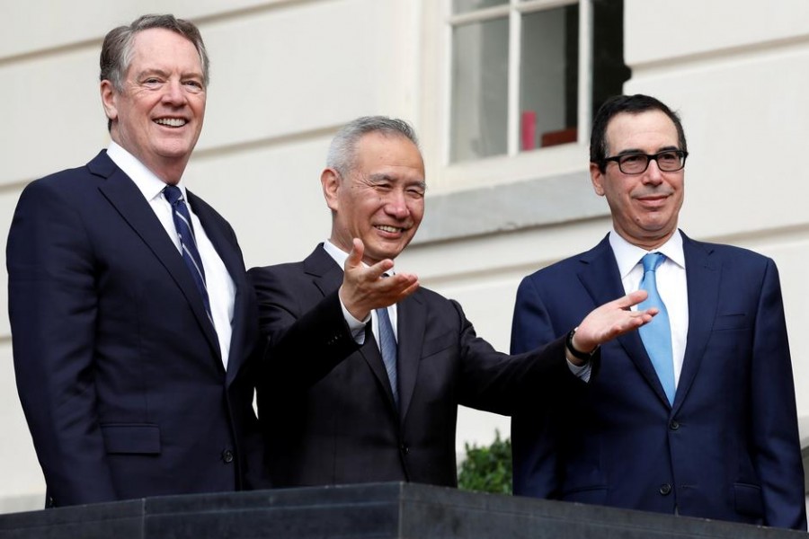 China's Vice Premier Liu He gestures to the media between US Trade Representative Robert Lighthizer (L) and Treasury Secretary Steve Mnuchin before the two countries' trade negotiations in Washington, US, October 10, 2019. Reuters