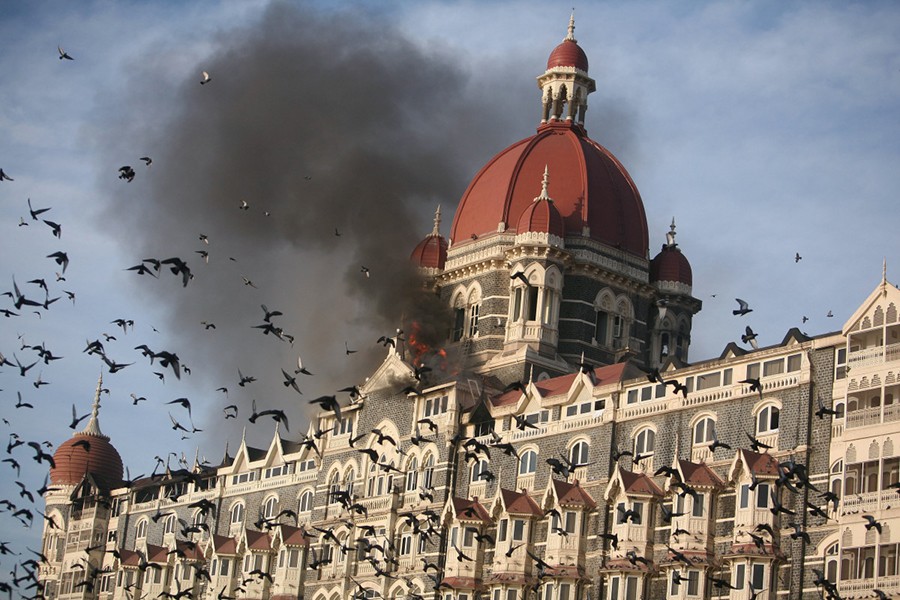 Pigeons fly near the burning Taj Mahal hotel in Mumbai November 27, 2008 — Reuters/Files