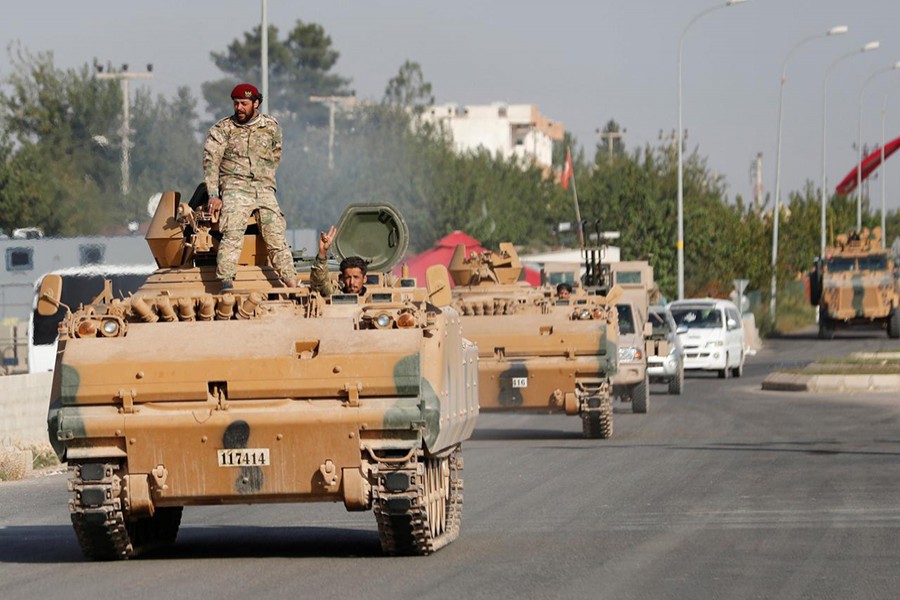 Members of Syrian National Army, known as Free Syrian Army, drive in an armoured vehicle in the Turkish border town of Ceylanpinar in Sanliurfa province, Turkey on October 11, 2019 — Reuters photo