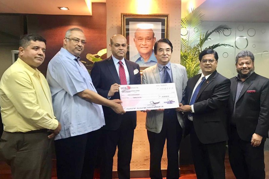 UCB hands over donation cheque  to AMDA International, Japan
