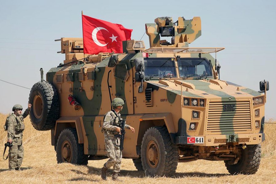 A Turkish soldier walks next to a Turkish military vehicle during a joint US-Turkey patrol, near Tel Abyad, Syria on September 8, 2019 — Reuters/Files