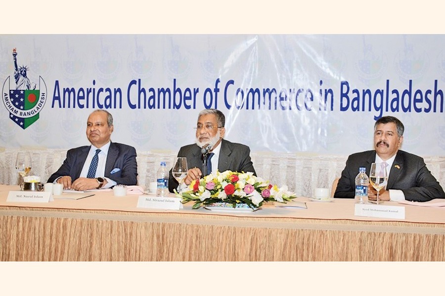 Executive Chairman of BIDA Md Sirazul Islam (centre) speaking at the Monthly Luncheon Meeting of American Chamber of Commerce in Bangladesh (AmCham) at a city hotel on Wednesday. AmCham President Md Nurul Islam (left) and Vice President Syed Mohammad Kamal (right) are also seen