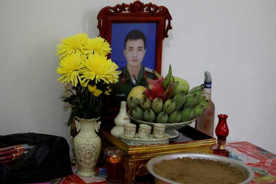 An image of Nguyen Dinh Tu, a Vietnamese suspected victim in a truck container in UK, is seen at a table at his home in Nghe An province, Vietnam October 26, 2019. Reuters