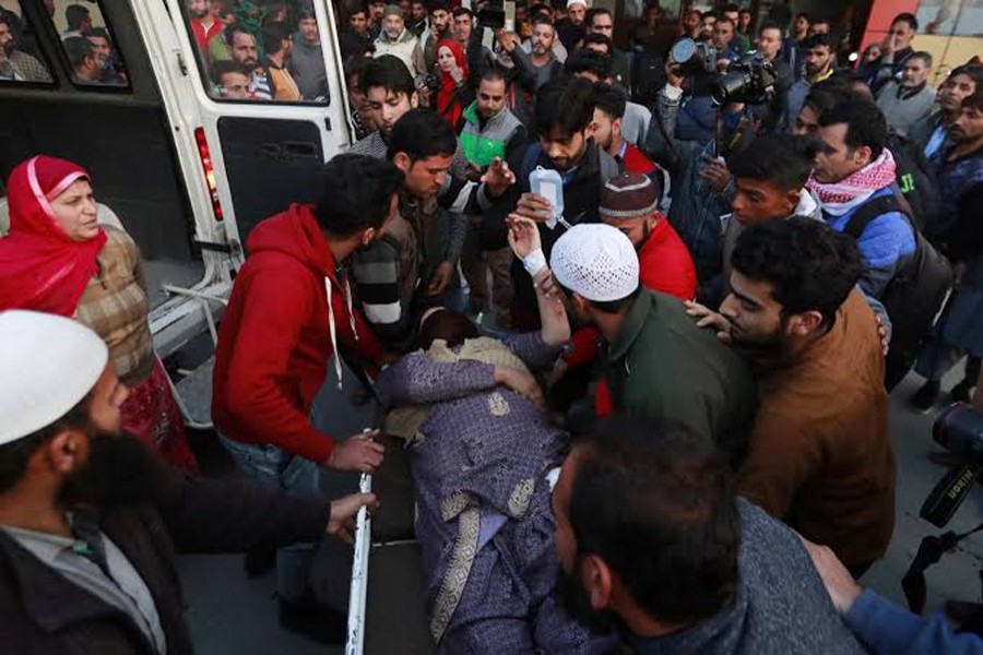 People rush a woman to a hospital for treatment after she was injured in a grenade blast in north Kashmir, in Srinagar, October 28, 2019. Reuters