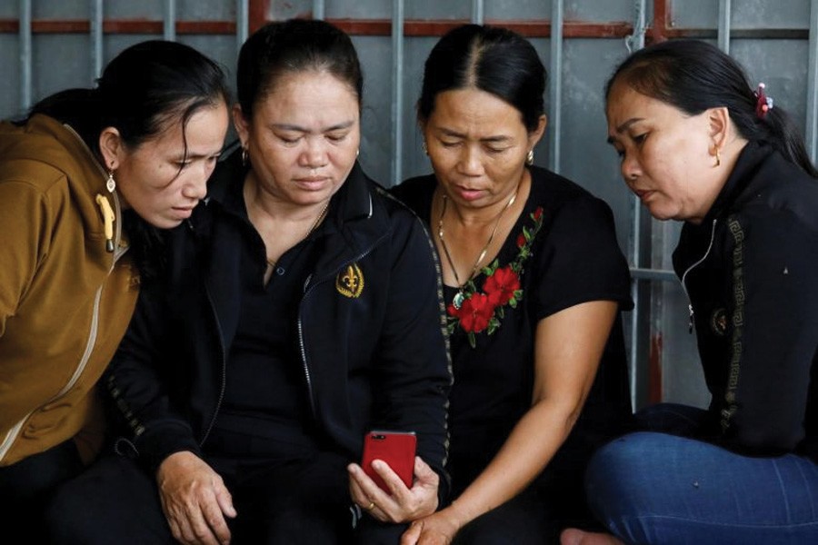 Relatives of Anna Bui Thi Nhung, a Vietnamese suspected to be among dead victims found in a lorry in Britain, reading news about her at her home in Nghe An province, Vietnam, on October 26, 2019. 	—Photo: Reuters