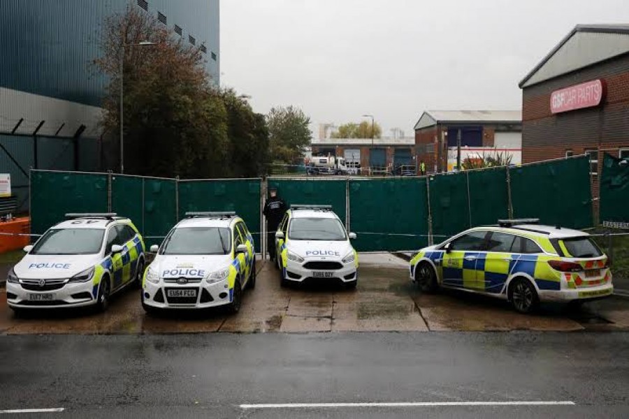 FILE PHOTO: Police vehicles are seen at the scene where bodies were discovered in a lorry container, in Grays, Essex, Britain October 24, 2019. REUTERS/Simon Dawson