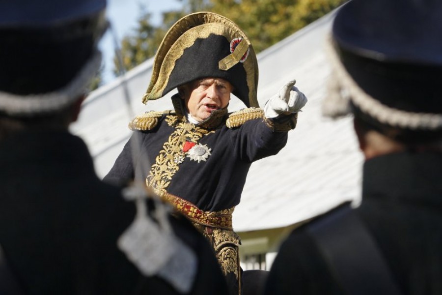 In this Sunday, Sept. 16, 2012 file photo, Oleg Sokolov, a history professor at St. Petersburg State University, wears a 1812-era French army general's uniforms during a staged battle re-enactment to mark the 200th anniversary of the battle of Borodino which in 1812 was the largest and bloodiest single-day action of the French invasion of Russia, in St. Petersburg, Russia. Dmitri Lovetsky—AP