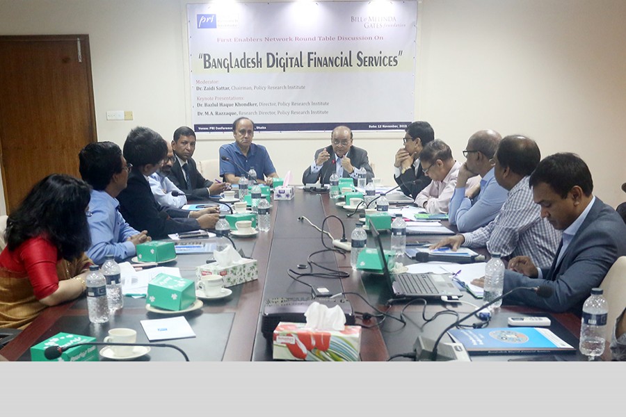 Chairman of Policy Research Institute of Bangladesh (PRI) Dr Zaidi Sattar (centre, right) speaking at a roundtable on 'Bangladesh Digital Financial Services' at the PRI conference room in the city on Tuesday. On his right is PRI Vice Chairman Dr Sadiq Ahmed — FE photo