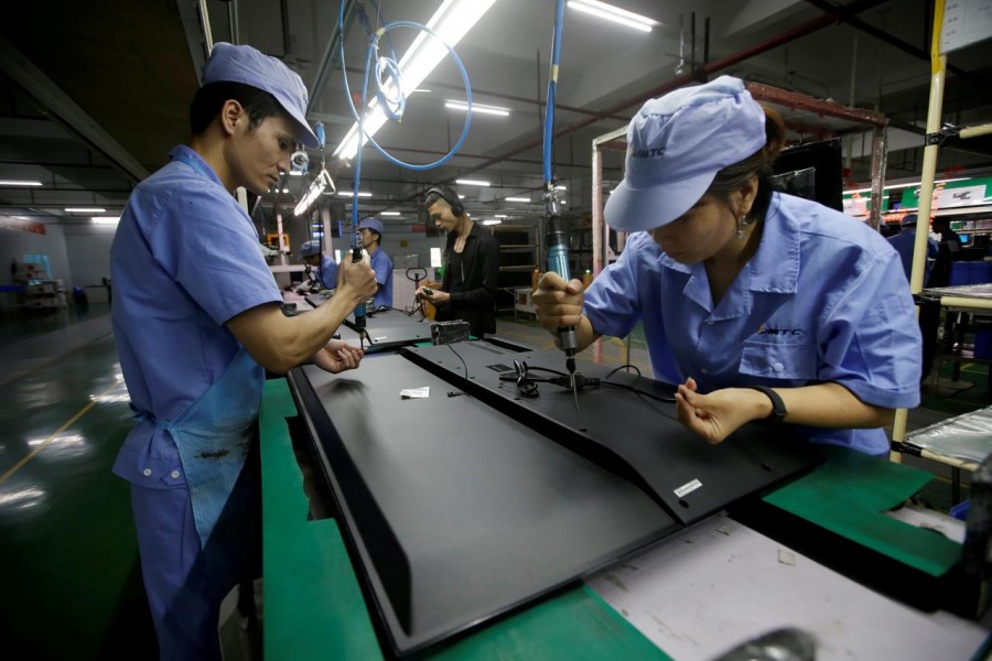Employees work on the production line of a television factory under Zhaochi Group in Shenzhen, China August 8, 2019. Reuters/File Photo