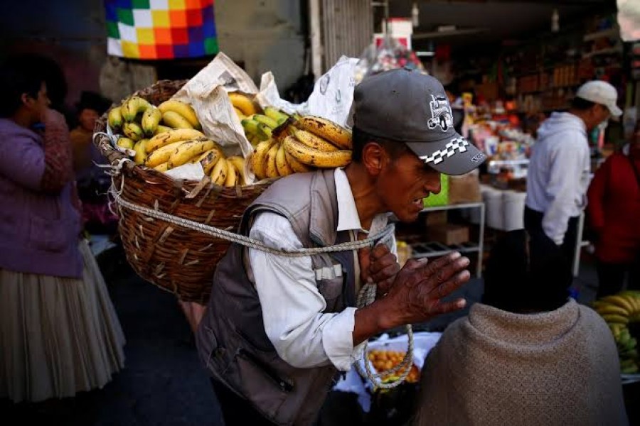 A man carries bananas at a street market in La Paz, Bolivia, November 17, 2019. REUTERS/David Mercado