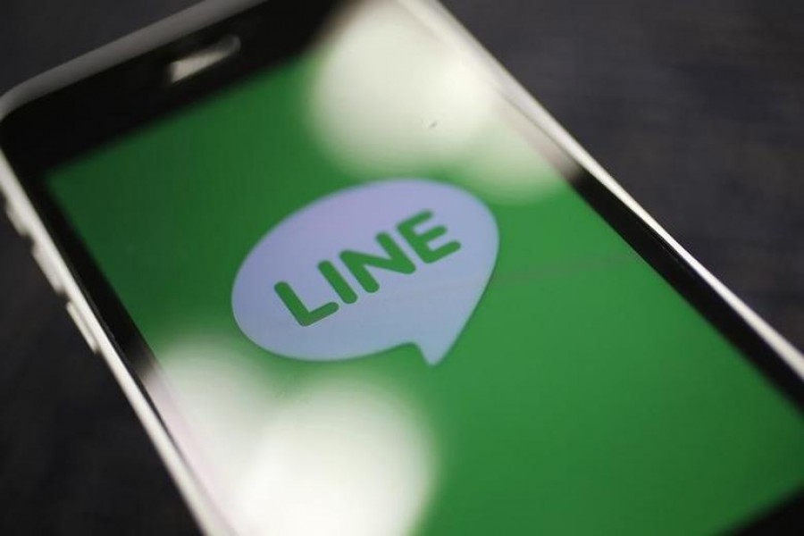 The logo of free messaging app Line is pictured on a smartphone in this photo illustration taken in Tokyo September 23, 2014. REUTERS/Toru Hanai