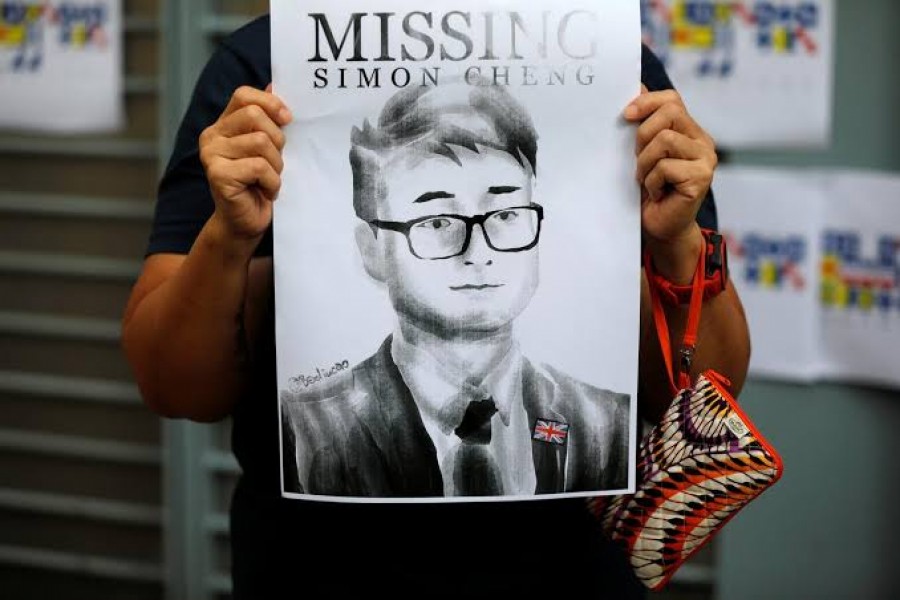A woman holds a poster of Simon Cheng, a staff member at the consulate who went missing on August 9 after visiting the neighbouring mainland city of Shenzhen, during a protest outside the British Consulate-general office in Hong Kong, China, August 21, 2019. REUTERS/Willy Kurniawan