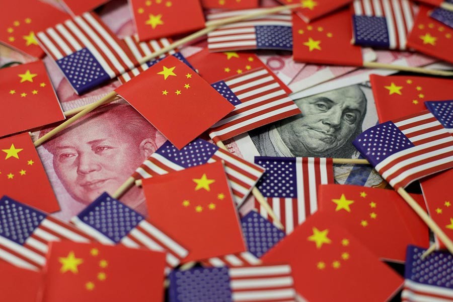 A US dollar banknote featuring American founding father Benjamin Franklin and a China's yuan banknote featuring late Chinese chairman Mao Zedong are seen among US and Chinese flags in this illustration picture taken May 20. -Reuters File Photo