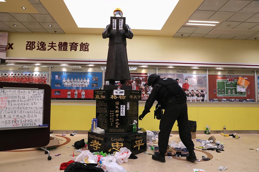 Member of a safety team established by police and local authorities inspects around a statue of Dr Sun Yat-sen, as they assess and clear unsafe items at the Hong Kong Polytechnic University (PolyU) in Hong Kong, China on November 28, 2019 — Reuters photo