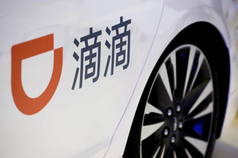FILE PHOTO: The logo of ride-hailing company Didi on a car door at the IEEV New Energy Vehicles Exhibition in Beijing, China, October 18, 2018. REUTERS/Thomas Peter/File Photo