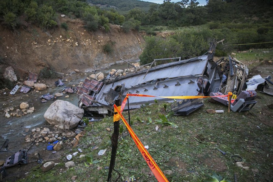 The debris of a regional bus that crashed off a hill are pictured on Sunday, December 1, 2019, causing the death of at least 24 passengers who were on an excursion in the Amdoun region, northern Tunisia — AP photo