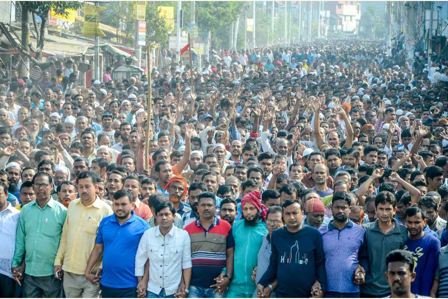Nine state-owned jute mill workers in Khulna brought out a procession on Monday demanding payment of wages to the workers 	— FE Photo