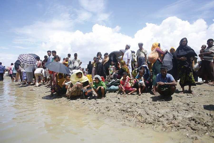 A group of Rohingyas after they fled Myanmar in 2017 arrive at Shahparir Dip in Teknaf, Bangladesh.             —Photo credit: IPS